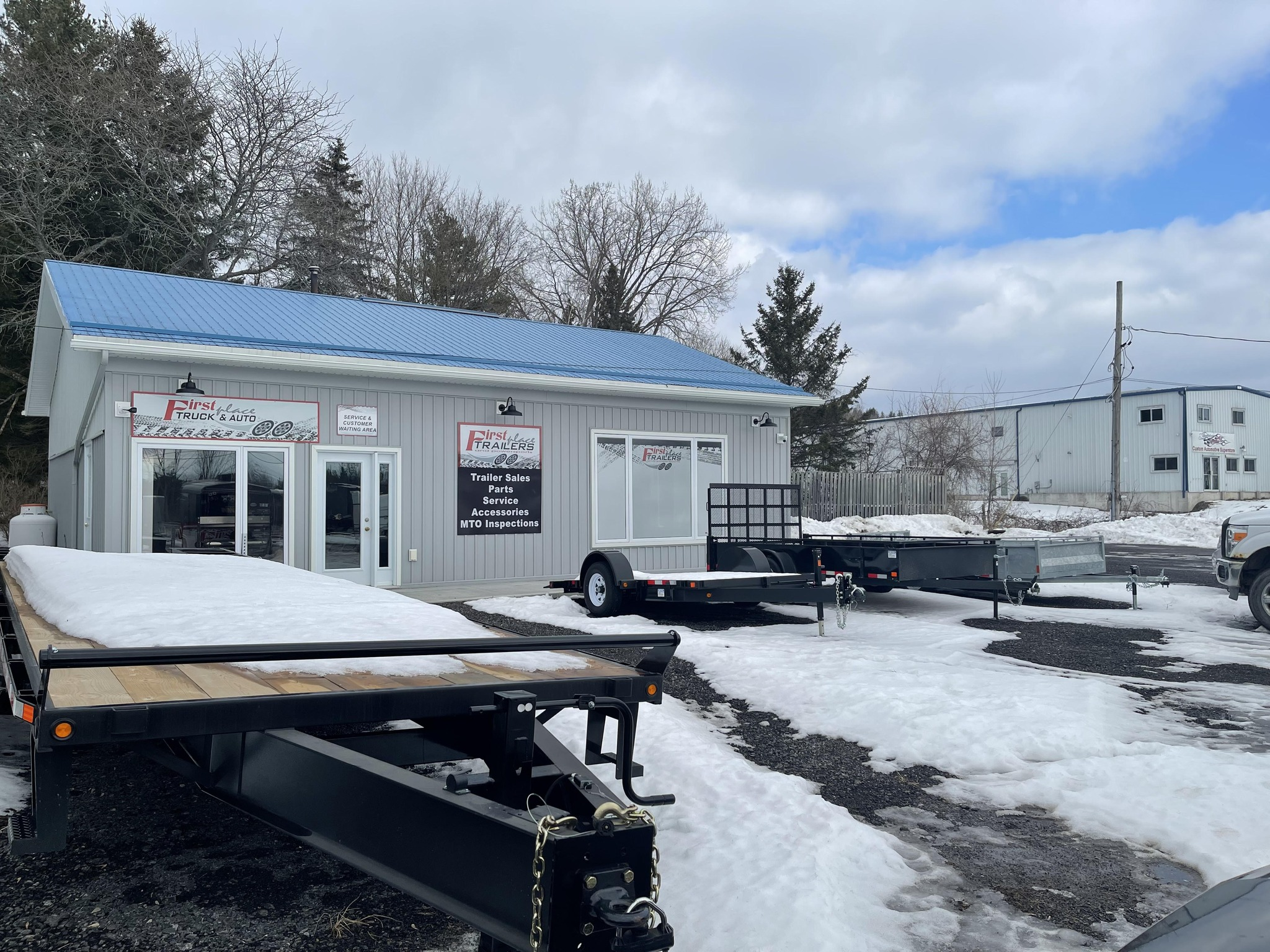 First Place Trailer - Business location with trailers displayed outside in winter